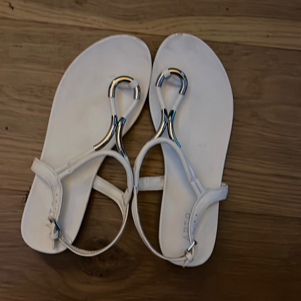 White sandals with silver ring thing